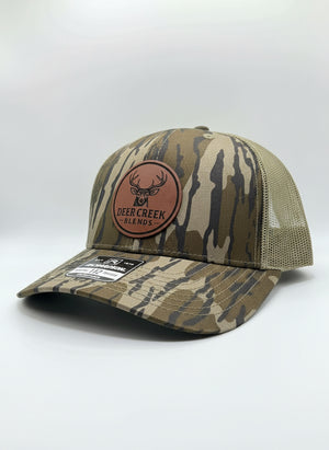 OG Logo Leather Patch Trucker Hat- Mossy Oak Bottomland™