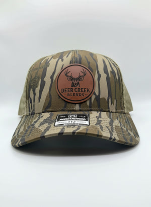 OG Logo Leather Patch Trucker Hat- Mossy Oak Bottomland™